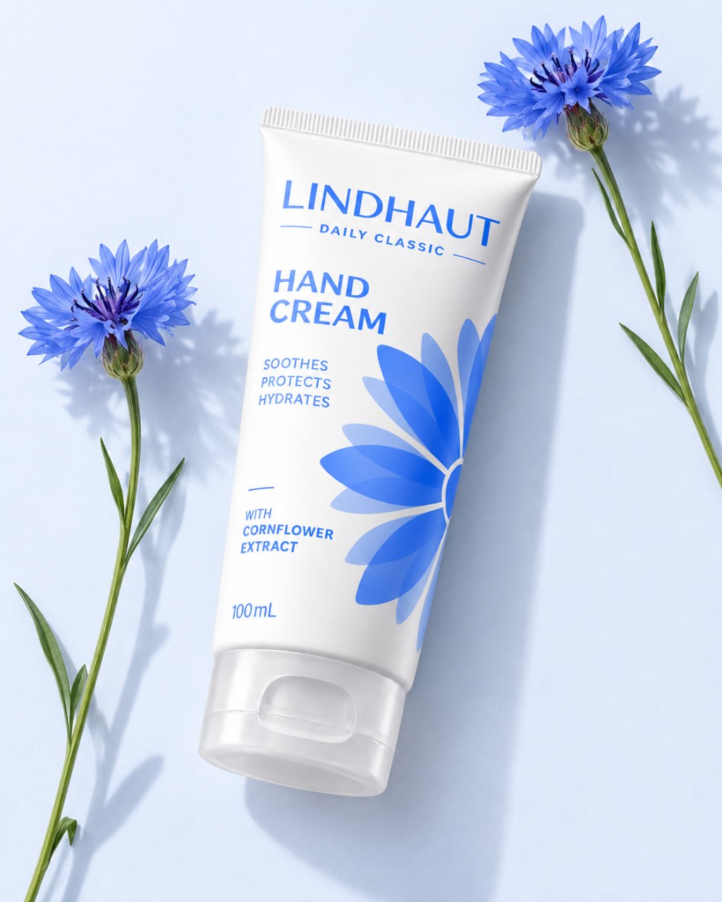 LINDHAUT Daily Classic tube laid flat between fresh cornflower stems