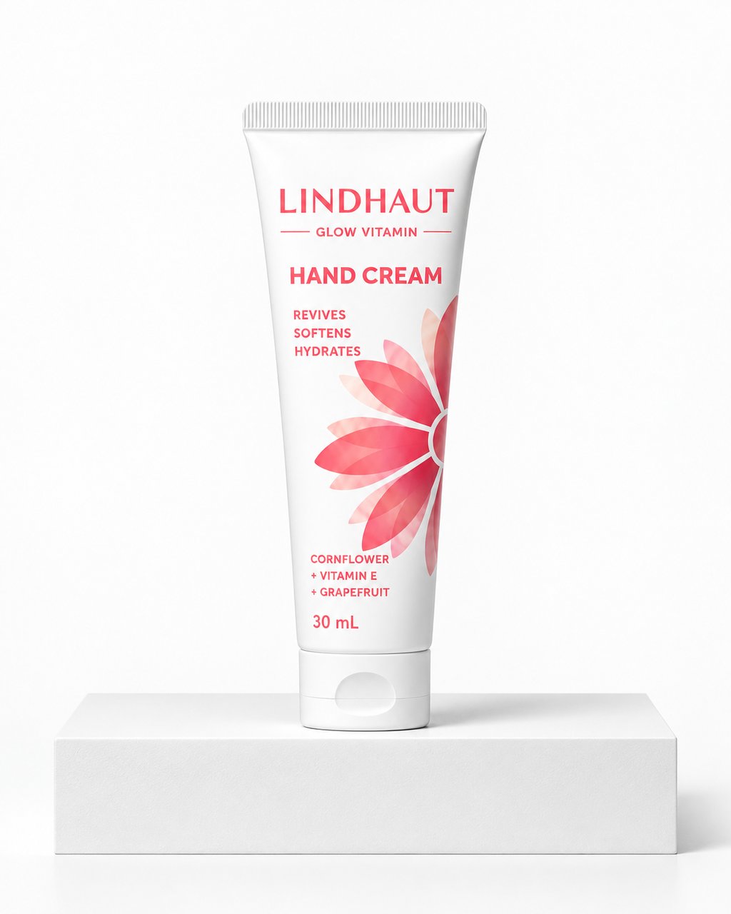 LINDHAUT Glow Vitamin hand cream, 30 mL tube standing on a white block
