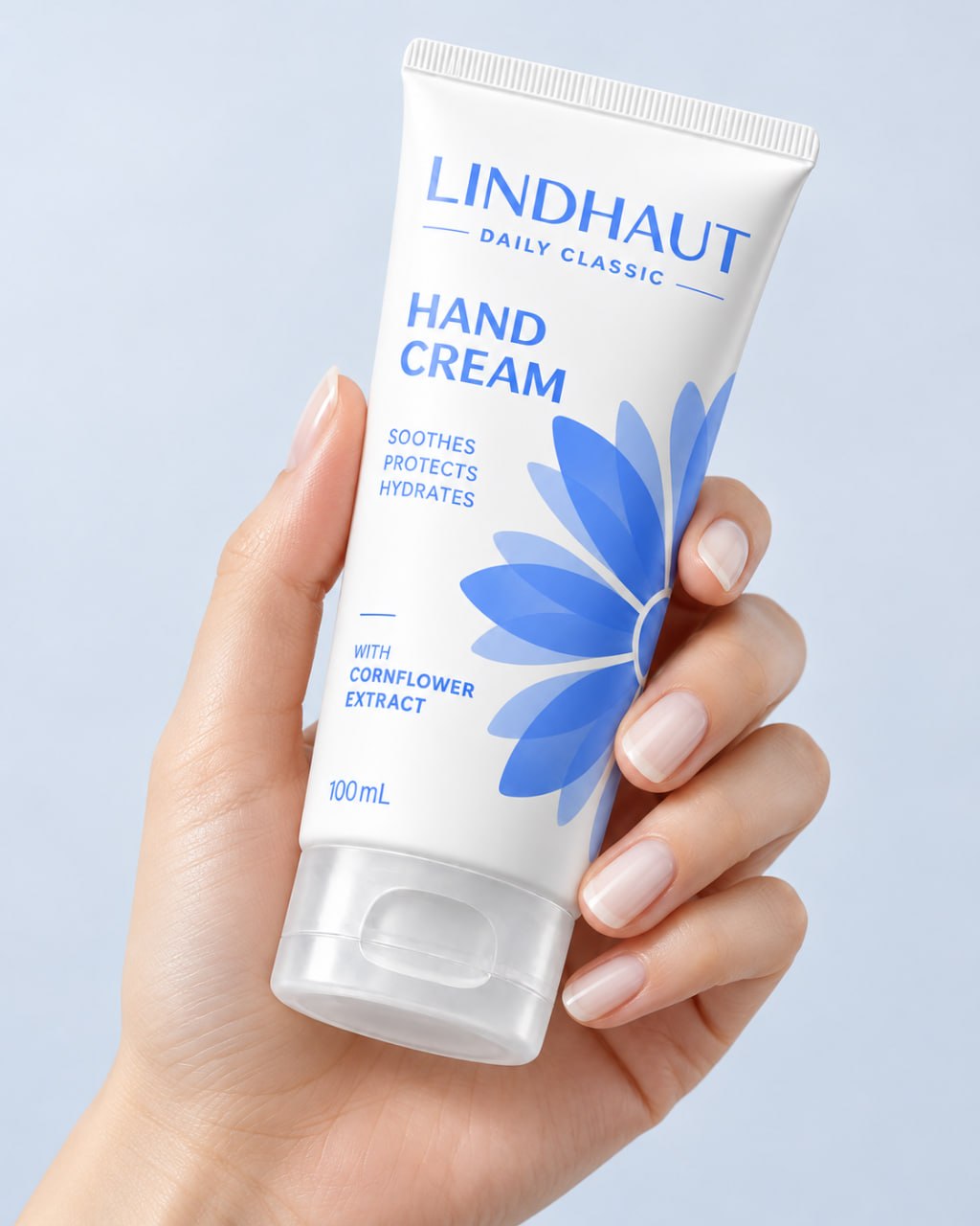 A hand holding the Daily Classic hand cream